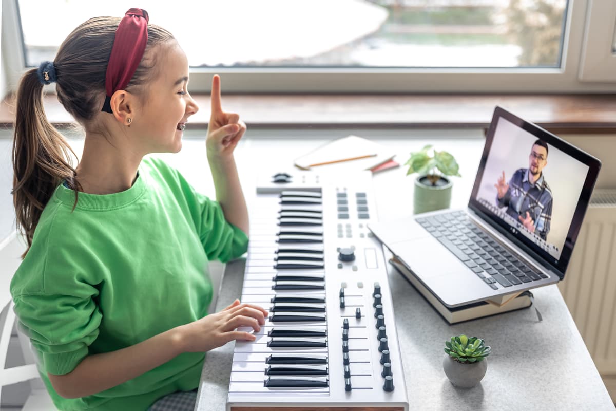Music teacher giving online piano lesson